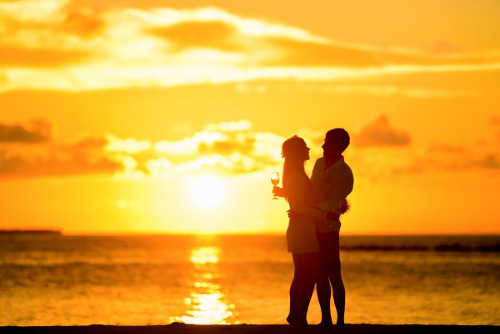 Two people on a date by the beach at sunset